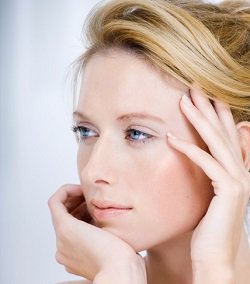 Beverly Hills female dermal filler patient model touching her face