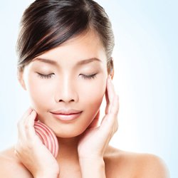 Skin Rejuvenation female patient model holding her face