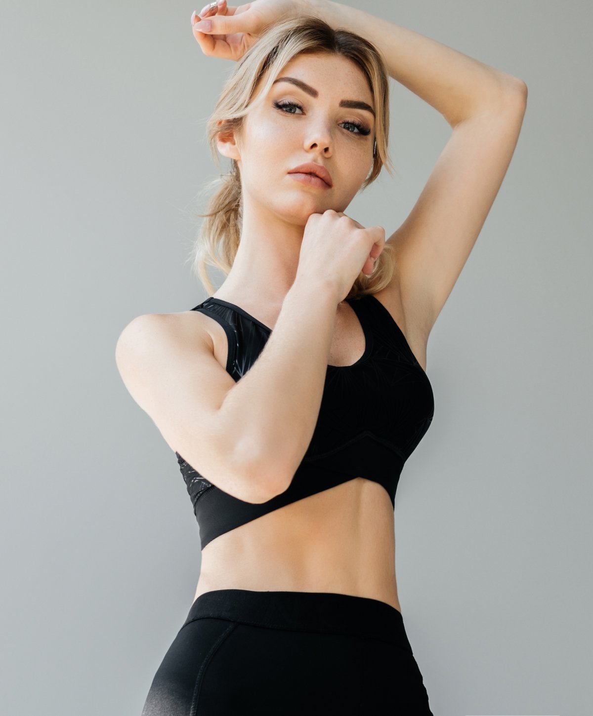 Female tummy tuck patient standing in exercise clothes